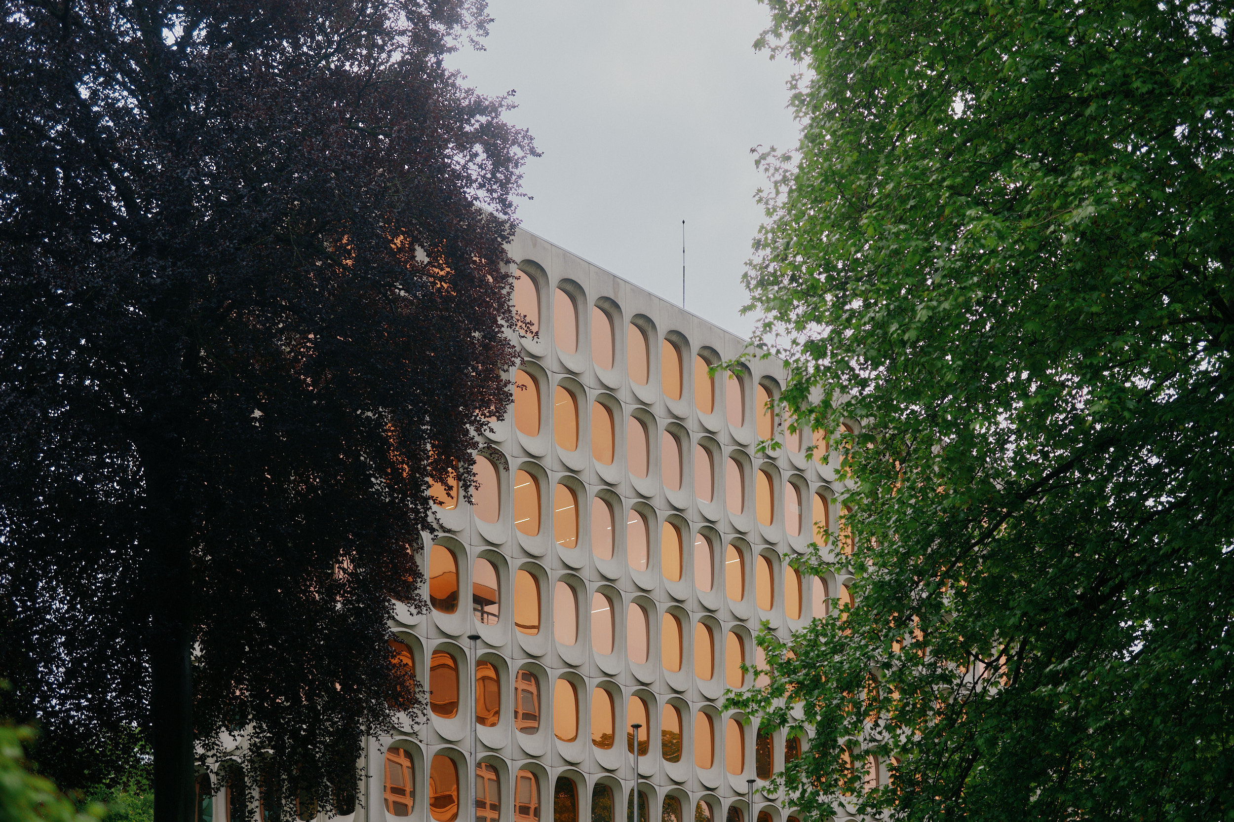 White concrete façade and recessed windows of the iconic CBR Building